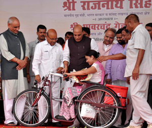 Union Home Minister Rajnath Singh with Union Minister of Social Justice and Empowerment Thawar Chand Gehlot distributing equipments to defferently abled persons at a function in Lucknow on Friday. (UNI)