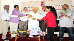 MLC Ashok Khajuria and others presenting certificate to a participant during conclusion of National Level Women Painters’ Camp by JKCCA on Sunday.