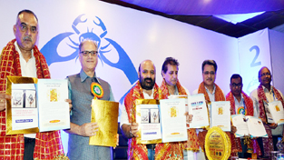 Minister for Health and Medical Education and others releasing souvenir of National Level Cancer Conference at Jammu on Saturday.