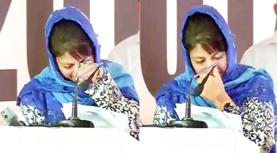 Chief Minister Mehbooba Mufti breaks down after hearing her father's voice in a video clip during a tourism promotion function in New Delhi on Tuesday. Chief Minister Mehbooba Mufti breaks down after hearing her father's voice in a video clip during a tourism promotion function in New Delhi on Tuesday.