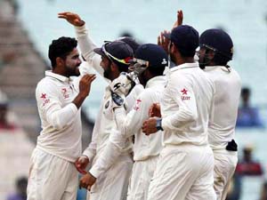 Indian players celebrate fall of New Zealand's batsman Luke Ronchi on the second day of the second cricket test match in Kolkata on Saturday. Indian players celebrate fall of New Zealand's batsman Luke Ronchi on the second day of the second cricket test match in Kolkata on Saturday.