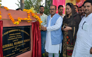 Deputy Chief Minister, Dr Nirmal Singh laying foundation stone of road at Billawar on Tuesday.