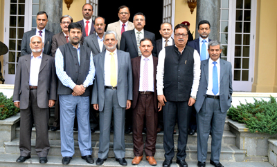 Outgoing Chairman of JK Bank Mushtaq Ahmad posing for photograph with top officers of the bank during farewell function.