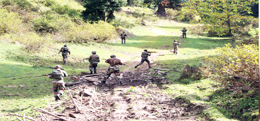 Army jawans in action during encounter in Marbal area of Zaloora, Sopore on Wednesday. —Excelsior photo