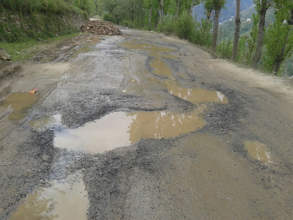 A badly damaged stretch of National Highway at Sherbibi in Ramban district on Sunday. Another pic on page 4 — Excelsior/Parvez