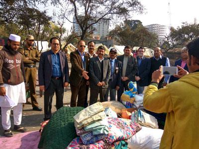 Rotary Club Jammu Tawi members donating relief material to fire victims of Narwal.