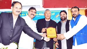 Minister for Cooperative & Ladakh Affairs Chering Dorjay and MP Jugal Kishore Sharma felicitating a functionary on Sunday.
