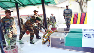 A senior Army officer laying wreath to pay respect to martyred soldiers at Rajouri on Wednesday.