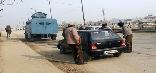 Security officials check vehicles on Srinagar- Jammu National Highway. -Excelsior/Shakeel