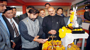 Minister for Forest Choudhary Lal Singh lighting traditional lamp during a function at Kathua on Saturday.