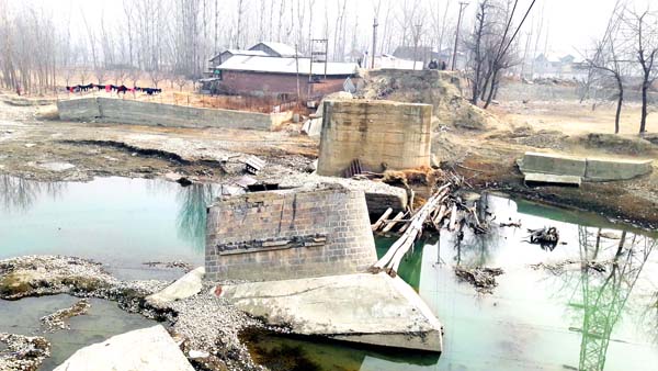 A view of a broken bridge that was damaged due to 2014 floods at Gadoora in Pulwama. -Excelsior/Younis Khaliq
