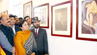 Minister of State for Culture and Tourism Priya Sethi looking at art work during an exhibition.