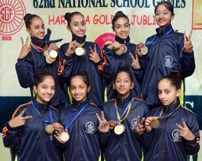 Ace State Gymnasts displaying medals while posing for a group photograph after sparkling in National School Games.