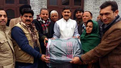 BJP MP, Jugal Kishore Sharma and party leader Ashwani Sharma distributing blankets among needy people at Powal in Bishnah on Saturday.