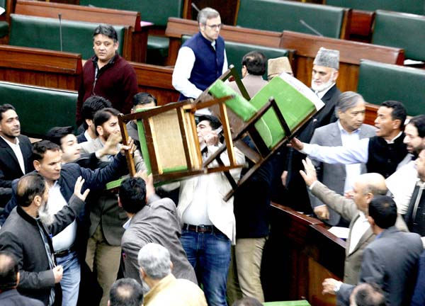 Amidst Opposition protests, NC MLA Altaf Ahmad Wani is seen throwing two chairs in the Assembly on Wednesday. Another pic on page 13. -Excelsior/Rakesh