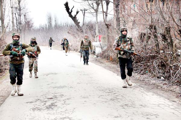 Troops take positions during encounter at Chitragam in Shopian on Thursday. -Excelsior/Younis Khaliq