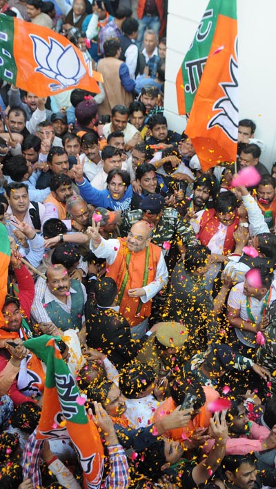 BJP president Amit Shah being given a grand welcome at party headquarters for the party's landslide victory in Uttar Pradesh Assembly election in New Delhi on Saturday.(UNI)