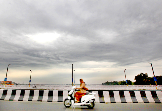 A scooterist moves amid dense clouds in Jammu on Tuesday morning. -Excelsior/Rakesh