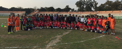 Young Footballers posing for a group photograph alongwith International Footballer Arun Malhotra and other dignitaries at MA Stadium in Jammu.
