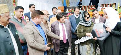 Chief Minister Mehbooba Mufti handing over keys of scooty to a girl student in Ganderbal on Tuesday.