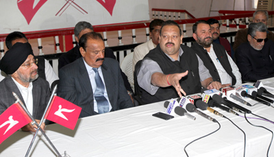 National Conference Provincial President Devender Singh Rana flanked by senior party leaders addressing press conference on Tuesday.