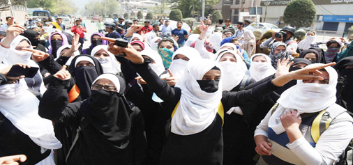 Students of Women’s College M A Road Srinagar stage protest against police action in Pulwama College on Monday. -Excelsior/Shakeel