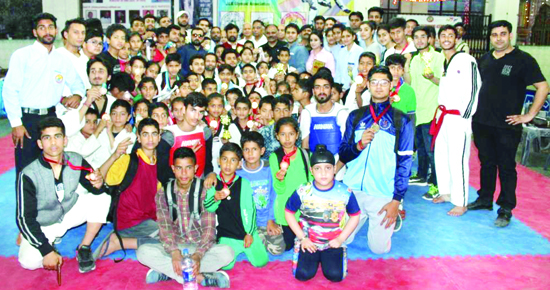Taekwondo players and officials during concluding ceremony in Jammu on Friday.