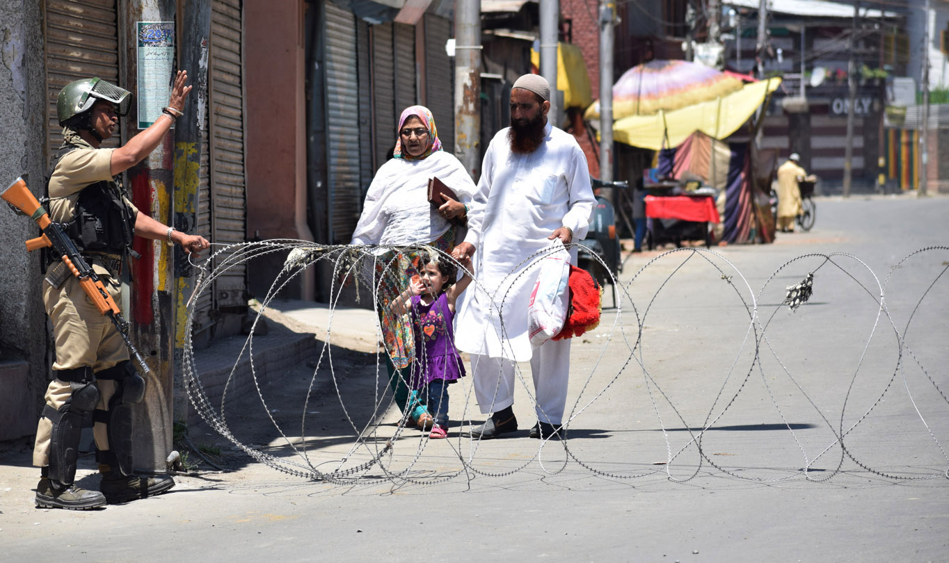 People being stopped from moving in Nowhatta area of Srinagar on Monday. -Excelsior/Shakeel
