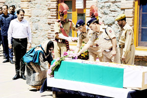 Chief Minister Mehbooba Mufti paying tributes to the killed DySP in Srinagar on Friday. -Excelsior/ Shakeel