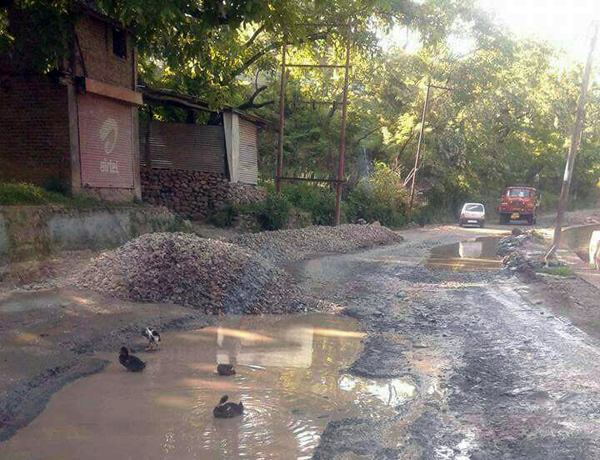 Safapora-Bandipora road strewn with potholes. -Excelsior/Aabid Nabi