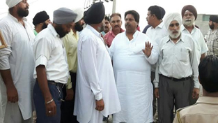 Cong leader Raman Bhalla interacting with Gadigarh people on Friday.