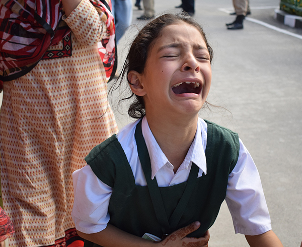 Daughter of policeman Abdul Rashid, cries after hearing news of her father’s killing in Anantnag on Monday. —Excelsior/Shakeel