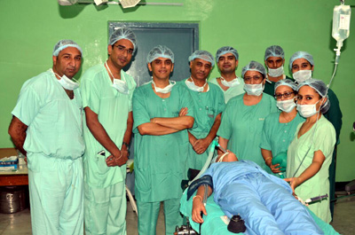 A team of doctors at ASCOMS Hospital which performed Bilateral Cochlear implant surgery posing with patient.