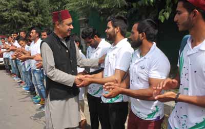 Minister for Horticulture, Syed Basharat Bukhari interacting with players during flag-off ceremony in Srinagar on Monday.