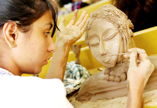 A girl participates in clay modelling at Jammu University’s ‘Display Your Talent’ on Friday. -Excelsior/Rakesh