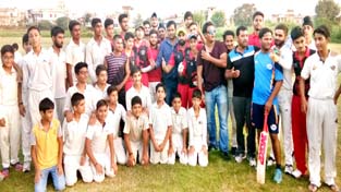 Jubilant players of KC Sports Club Juniors team posing for a group photograph along with budding cricketers and Management of the Club.