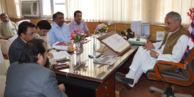 Minister for Revenue, A R Veeri chairing a meeting at Srinagar on Monday.