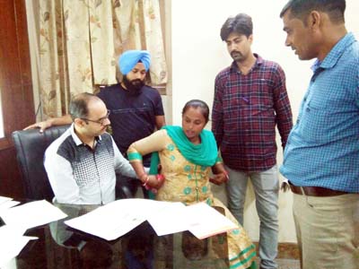 A doctor examining a patient during a BMD test camp at Hargun Hospital’s OPD clinic at Jammu.