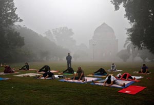 People exercise in a park on a smoggy morning in New Delhi. (UNI)