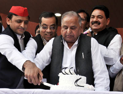Samajwadi Party patriarch Mulayam Singh Yadav along with his son and the national president of the party during his 79th birthday celebration hosted by Akhilesh Yadav at party office in Lucknow on Wednesday. (UNI)