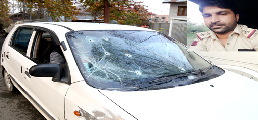 A car damaged in a shoot-out at Zakoora, Srinagar on Friday. (Inset) Imran Tak. —Excelsior/Shakeel
