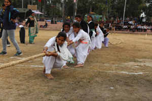 Young girls in action during Tug-of-War competition at Sports Festival in Reasi.