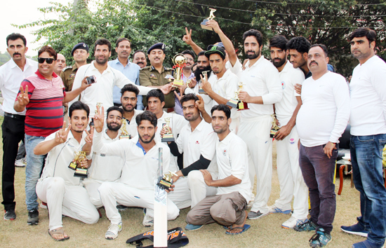 Jubilant players of Srinagar Eleven posing for a group photograph after winning T20 title in Jammu.