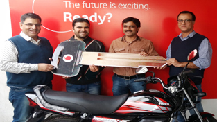 Vodafone presenting the key of a Hero motorcycle to the "Challenge to Win Season 19" winner Pawan Sharma at Jammu on Thursday.