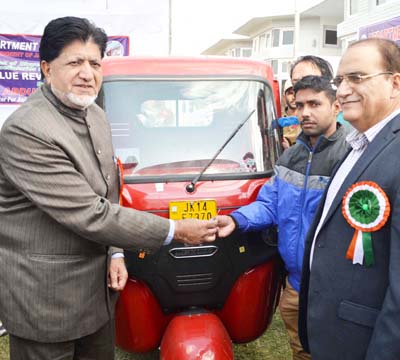 Minister for Animal Husbandry, Abdul Gani Kohli giving a key of auto-rickshaw to a fisherman on Wednesday.