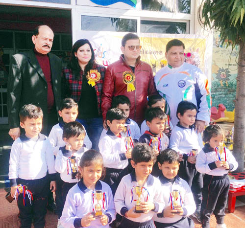 Winners of sporting events at Kids Campus posing along with dignitaries on Wednesday.
