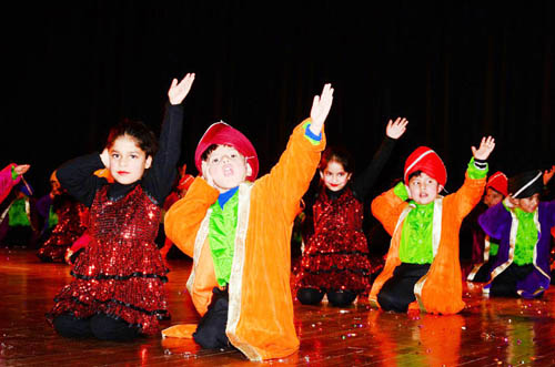 Students presenting colourful cultural item during Annual Day of Sprawling Buds and Apple Kids in Jammu.