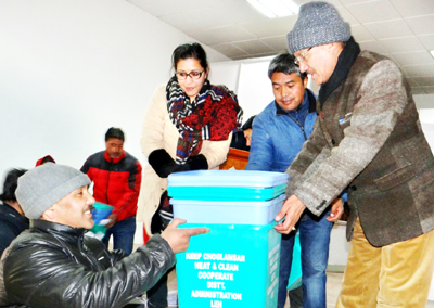 CEC distributing coloured dustbins to residents and shopkeepers of Choglamsar in Leh on Wednesday.