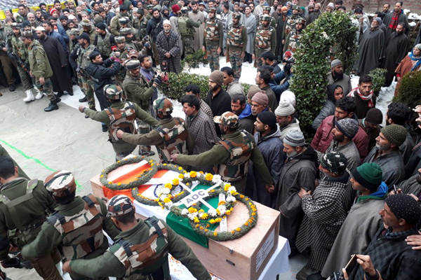 Troops and people pay tributes to Army martyr at Kewer, Qazigund in Anantnag district on Tuesday. -Excelsior/Sajad Dar