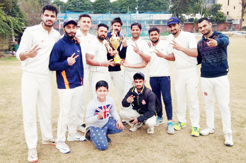 Jubilant players of NCC Jammu posing for a group photograph after lifting T20 title at KCSC in Jammu.